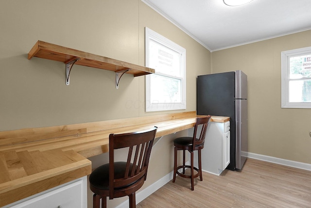 1086 S Hampton Rd, Columbus, OH 43227 - office area with ornamental molding, built in desk, and light wood-style floors