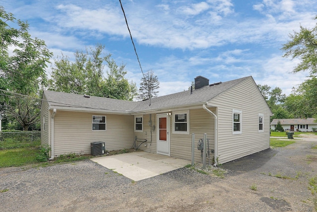 1086 S Hampton Rd, Columbus, OH 43227 - rear view of house featuring a patio, roof with shingles, and a chimney