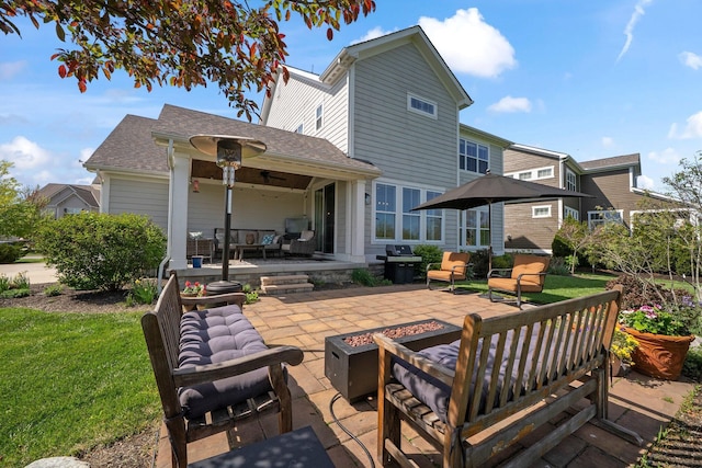 10640 Honeysuckle Way, Plain City, OH 43064 - back of house with an outdoor living space with a fire pit, a patio, roof with shingles, and a lawn