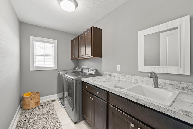 10640 Honeysuckle Way, Plain City, OH 43064 - laundry room with cabinet space, separate washer and dryer, light tile patterned flooring, and a textured ceiling