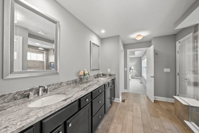 10640 Honeysuckle Way, Plain City, OH 43064 - full bathroom with a shower stall, double vanity, wood finished floors, and recessed lighting