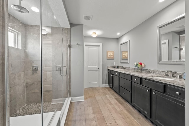 10640 Honeysuckle Way, Plain City, OH 43064 - bathroom featuring a stall shower, double vanity, wood finished floors, and recessed lighting