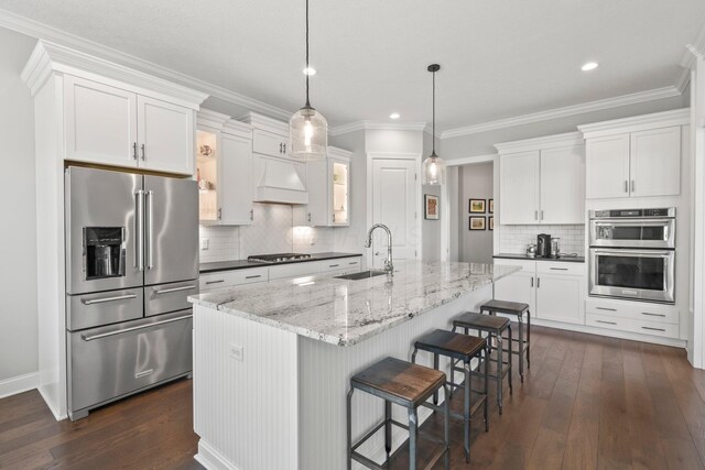 10640 Honeysuckle Way, Plain City, OH 43064 - kitchen with stainless steel appliances, premium range hood, dark wood-style floors, backsplash, and white cabinetry