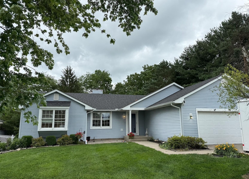 1885 Itawamba Trl, London, OH 43140 - ranch-style house featuring an attached garage, roof with shingles, a front yard, and a chimney