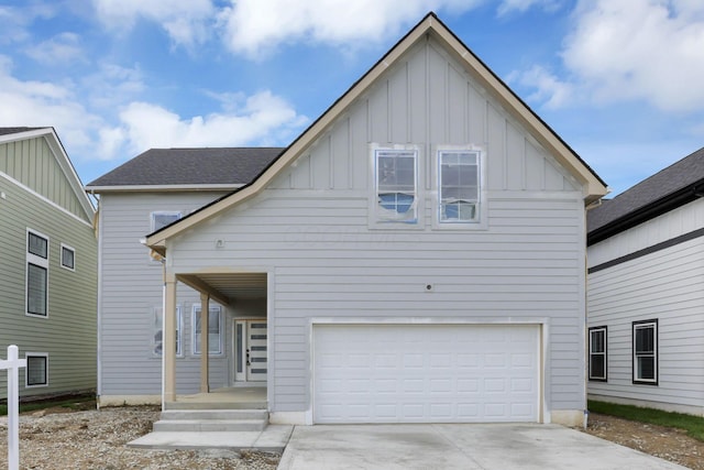 3699 Kassidy Dr, Grove City, OH 43123 - view of front facade featuring board and batten siding, an attached garage, and driveway