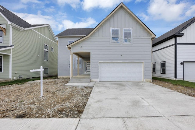 3699 Kassidy Dr, Grove City, OH 43123 - view of front of property with board and batten siding, an attached garage, and concrete driveway