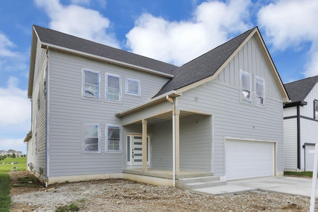 3699 Kassidy Dr, Grove City, OH 43123 - view of front facade with board and batten siding, concrete driveway, a porch, and an attached garage