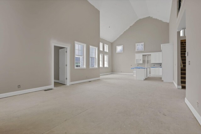 3699 Kassidy Dr, Grove City, OH 43123 - unfurnished living room with high vaulted ceiling and baseboards