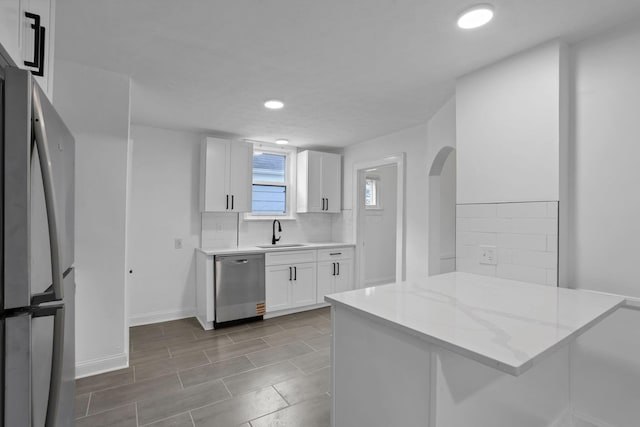 794 E Deshler Ave, Columbus, OH 43206 - kitchen featuring stainless steel appliances, tasteful backsplash, white cabinetry, light stone countertops, and recessed lighting