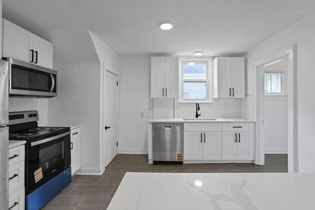 794 E Deshler Ave, Columbus, OH 43206 - kitchen with stainless steel appliances, decorative backsplash, and plenty of natural light