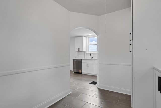 794 E Deshler Ave, Columbus, OH 43206 - hallway with arched walkways and dark tile patterned flooring