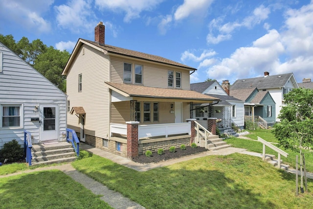 794 E Deshler Ave, Columbus, OH 43206 - view of front of house featuring a front lawn, a porch, and a chimney