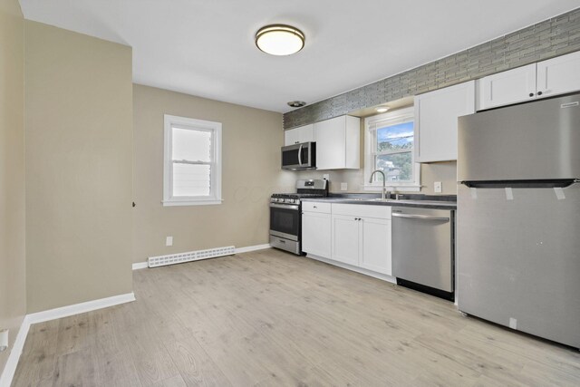 678 E Fair Ave, Lancaster, OH 43130 - kitchen with stainless steel appliances, white cabinets, and light wood finished floors