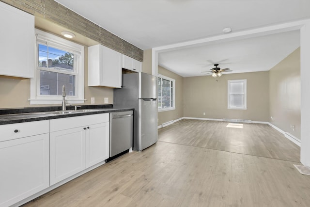 678 E Fair Ave, Lancaster, OH 43130 - kitchen with appliances with stainless steel finishes, white cabinetry, dark countertops, light wood-style floors, and ceiling fan
