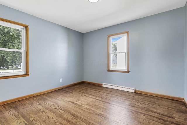 678 E Fair Ave, Lancaster, OH 43130 - spare room featuring a baseboard heating unit, healthy amount of natural light, and wood finished floors