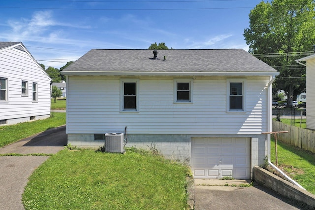 678 E Fair Ave, Lancaster, OH 43130 - rear view of house with a garage, a shingled roof, and concrete driveway