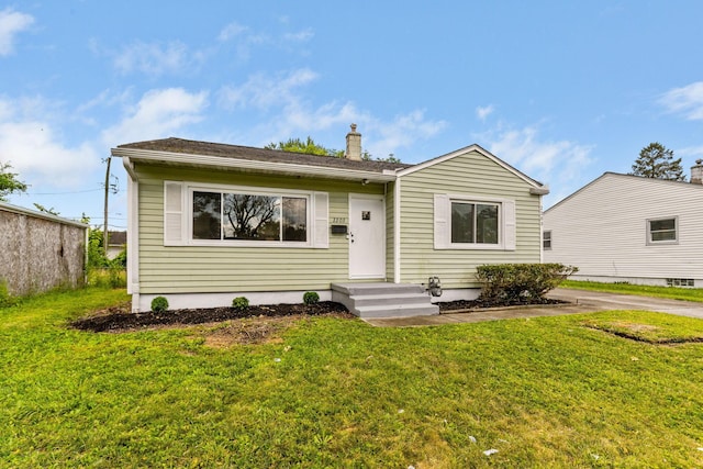 2203 Belcher Dr, Columbus, OH 43224 - view of front of house with a front lawn and a chimney
