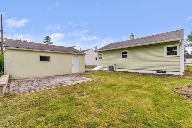2203 Belcher Dr, Columbus, OH 43224 - rear view of property with a patio area, a lawn, a chimney, and roof with shingles