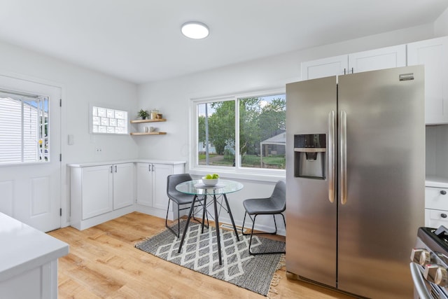 2203 Belcher Dr, Columbus, OH 43224 - kitchen with appliances with stainless steel finishes, light wood-type flooring, white cabinets, light countertops, and open shelves