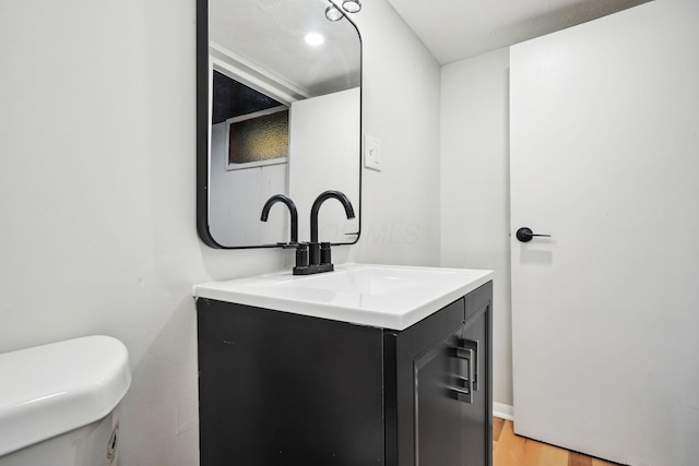 1358 Moler Rd, Columbus, OH 43207 - half bathroom with vanity and wood finished floors