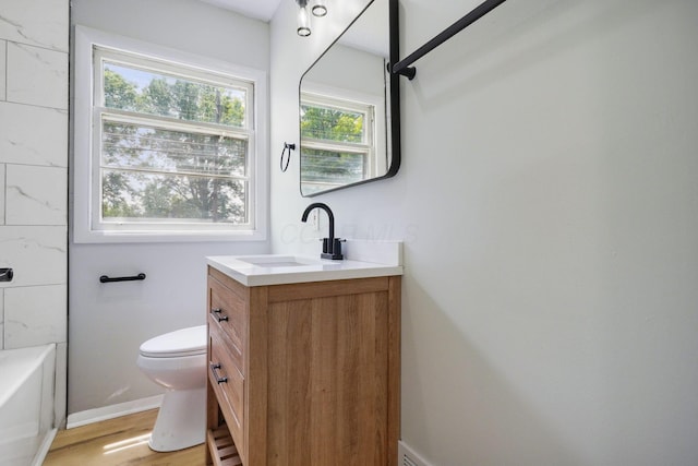 1358 Moler Rd, Columbus, OH 43207 - bathroom with vanity, wood finished floors, and shower / bathtub combination