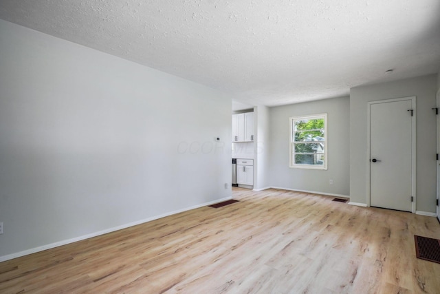 1358 Moler Rd, Columbus, OH 43207 - spare room with light wood-type flooring and a textured ceiling