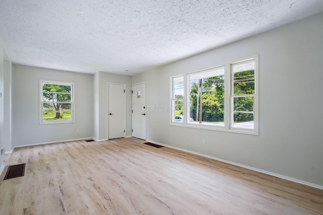 1358 Moler Rd, Columbus, OH 43207 - entrance foyer featuring wood finished floors, a textured ceiling, and plenty of natural light