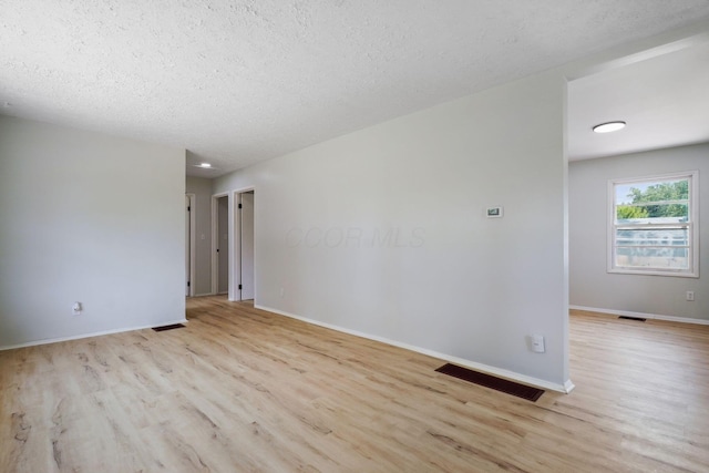 1358 Moler Rd, Columbus, OH 43207 - empty room with light wood-style floors and a textured ceiling