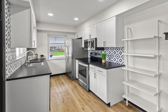 1861 Berkeley Rd, Columbus, OH 43207 - kitchen with stainless steel appliances, dark countertops, open shelves, white cabinets, and recessed lighting