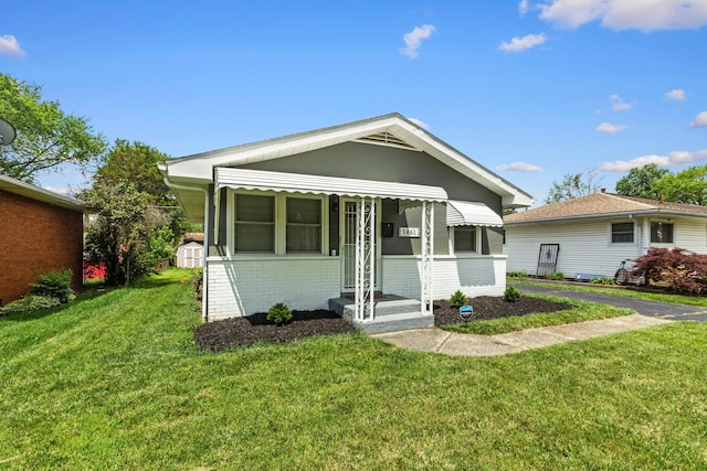 1861 Berkeley Rd, Columbus, OH 43207 - view of front facade with brick siding, a front yard, and a storage shed