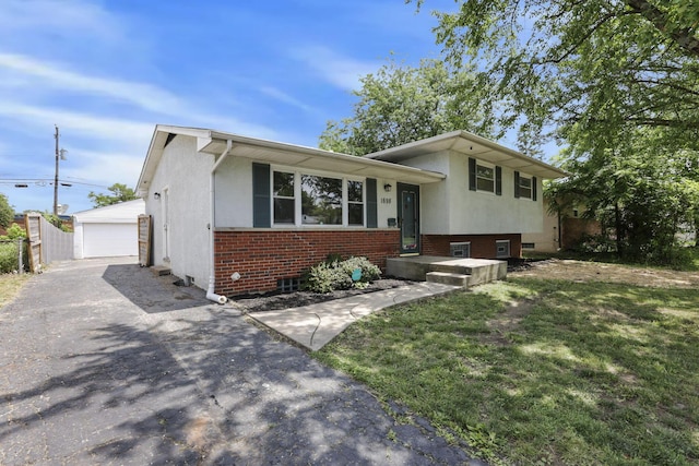 1698 Woodcrest Rd, Columbus, OH 43232 - split level home with a detached garage, an outdoor structure, brick siding, and stucco siding