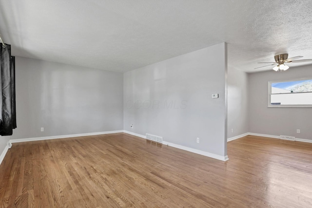 1698 Woodcrest Rd, Columbus, OH 43232 - empty room with light wood-style floors, a ceiling fan, and a textured ceiling