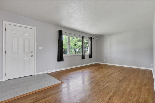 1698 Woodcrest Rd, Columbus, OH 43232 - foyer featuring wood finished floors and a textured ceiling