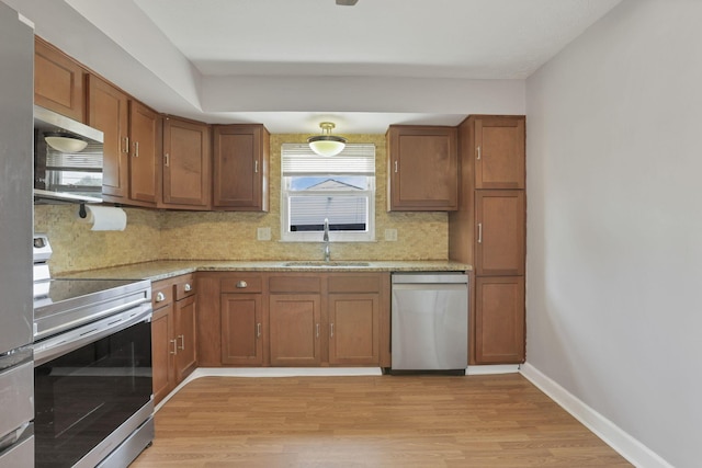 1698 Woodcrest Rd, Columbus, OH 43232 - kitchen featuring appliances with stainless steel finishes, light wood-style flooring, decorative backsplash, and plenty of natural light