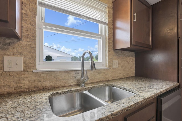 1698 Woodcrest Rd, Columbus, OH 43232 - kitchen with decorative backsplash, dark brown cabinets, and light stone counters