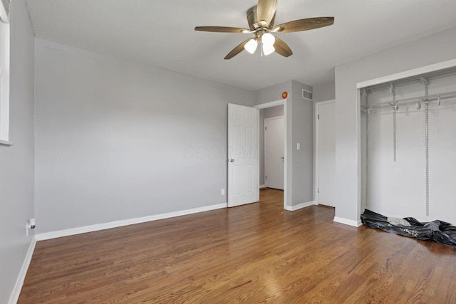 1698 Woodcrest Rd, Columbus, OH 43232 - unfurnished bedroom featuring wood finished floors, a closet, and a ceiling fan