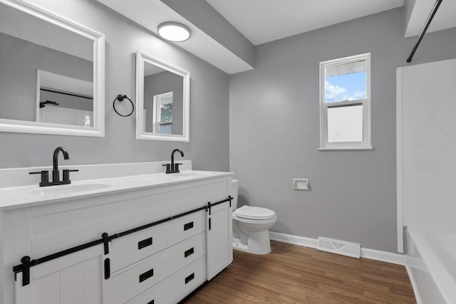 1698 Woodcrest Rd, Columbus, OH 43232 - bathroom featuring double vanity and wood finished floors
