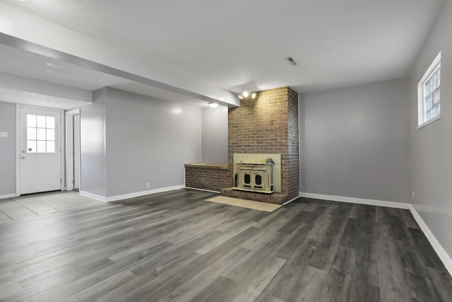1698 Woodcrest Rd, Columbus, OH 43232 - unfurnished living room with a brick fireplace, healthy amount of natural light, and wood finished floors