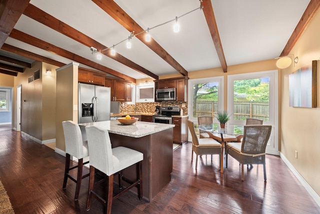 2474 Bristol Rd, Columbus, OH 43221 - kitchen featuring appliances with stainless steel finishes, rail lighting, beamed ceiling, backsplash, and dark wood-style floors
