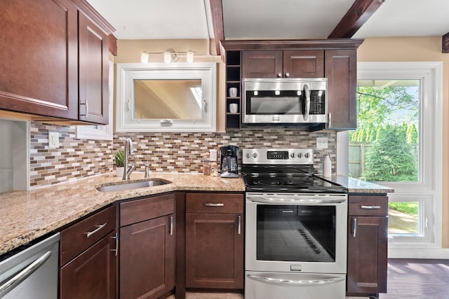 2474 Bristol Rd, Columbus, OH 43221 - kitchen with stainless steel appliances, backsplash, light stone counters, and dark brown cabinets