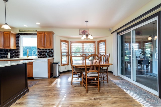 1163 Sitterley Rd NW, Canal Winchester, OH 43110 - kitchen with white dishwasher, a chandelier, light wood-style floors, pendant lighting, and recessed lighting