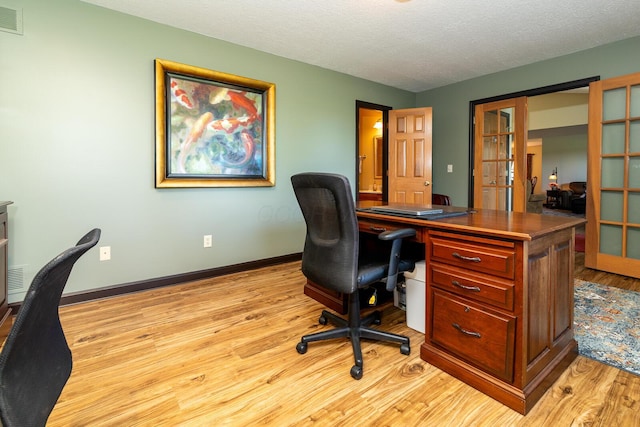 1163 Sitterley Rd NW, Canal Winchester, OH 43110 - home office featuring french doors, light wood-type flooring, and a textured ceiling