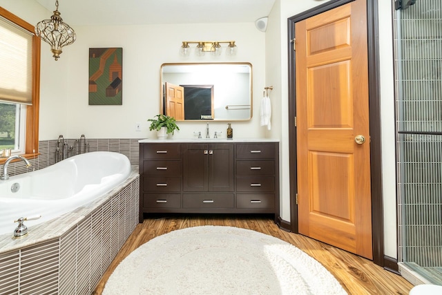 1163 Sitterley Rd NW, Canal Winchester, OH 43110 - full bathroom with vanity, a bath, a heating unit, and wood finished floors
