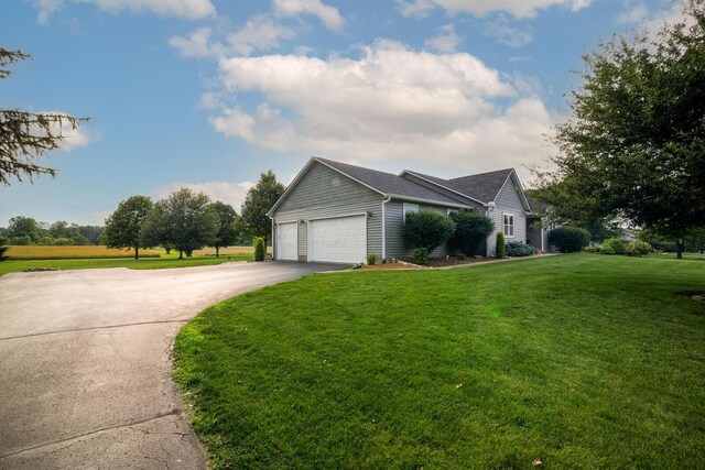 1163 Sitterley Rd NW, Canal Winchester, OH 43110 - view of front of home featuring asphalt driveway, a garage, and a front yard