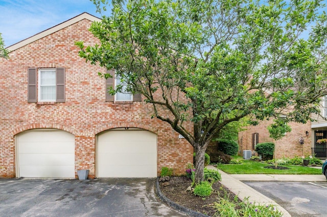 5092 Schuylkill St Unit 31-92, Columbus, OH 43220 - view of front of home with driveway, a garage, and brick siding