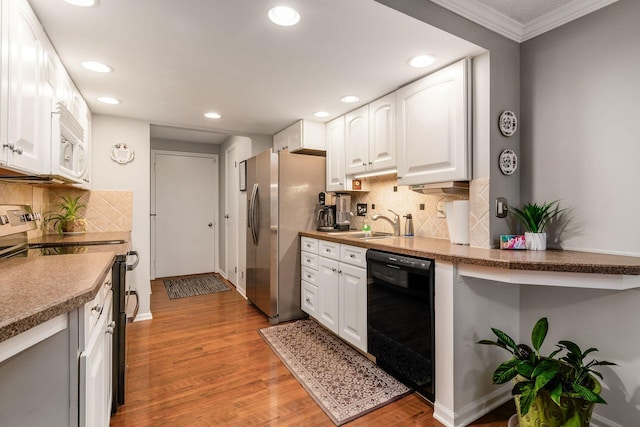 5092 Schuylkill St Unit 31-92, Columbus, OH 43220 - kitchen featuring appliances with stainless steel finishes, recessed lighting, light wood-style flooring, white cabinets, and decorative backsplash