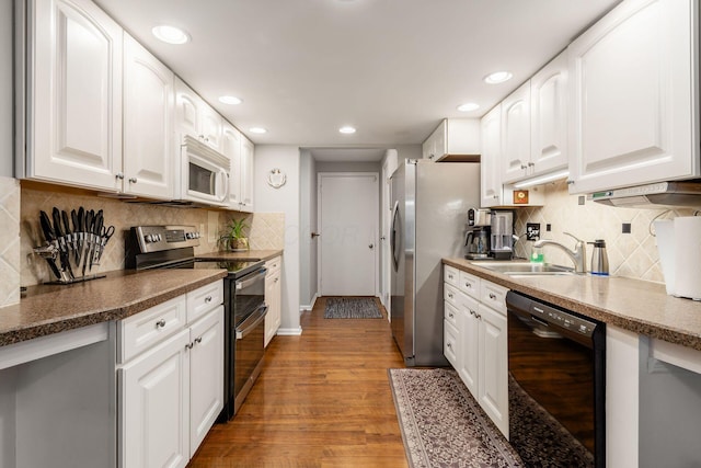 5092 Schuylkill St Unit 31-92, Columbus, OH 43220 - kitchen with stainless steel appliances, decorative backsplash, white cabinets, and recessed lighting
