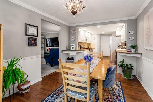5092 Schuylkill St Unit 31-92, Columbus, OH 43220 - dining area with wood finished floors, a chandelier, crown molding, and recessed lighting