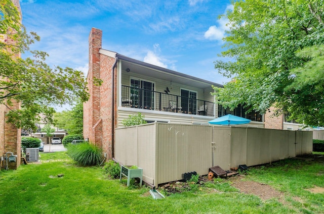 5092 Schuylkill St Unit 31-92, Columbus, OH 43220 - rear view of property featuring a balcony, a yard, and a chimney