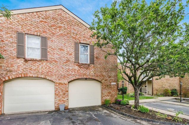 5092 Schuylkill St Unit 31-92, Columbus, OH 43220 - view of front of house featuring an attached garage, driveway, and brick siding